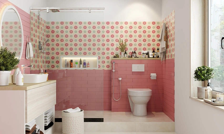 Low-cost Indian bathroom design which has bright pink floral tiles for a cheerful look