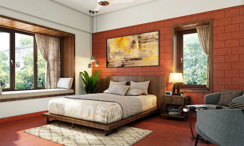 Bedroom with terracotta accent wall featuring earthy interior design finishes and natural textures