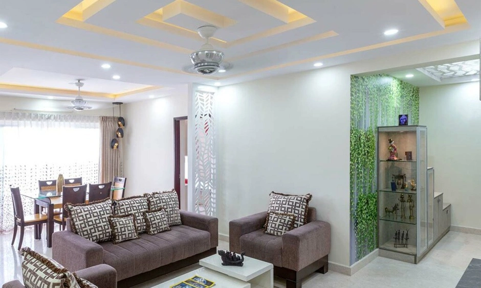 A spacious open-concept L-shaped room effortlessly combining an entryway, living lounge, and dining zone.