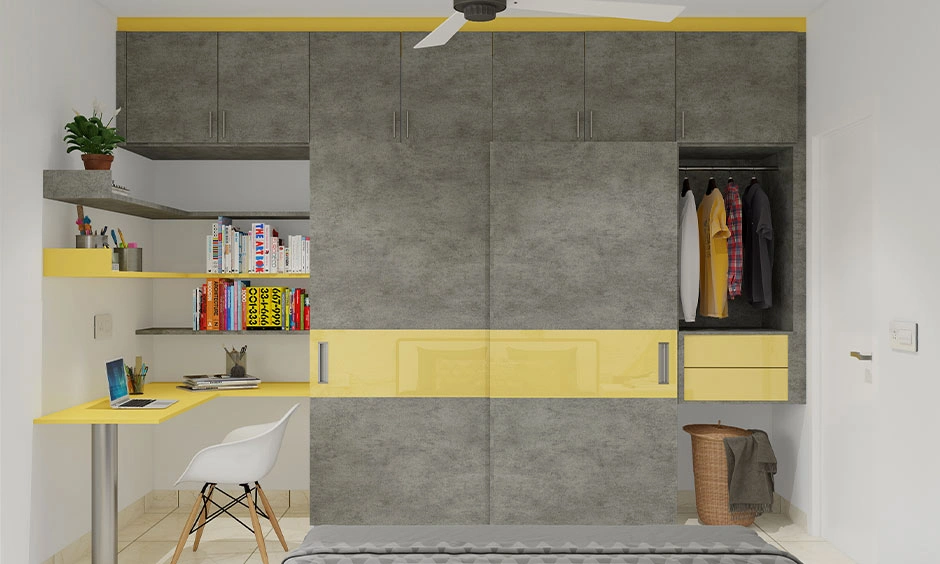 Concrete-finish kids wardrobe meets a bold yellow desk in an L-shaped configuration to maximize floor space.
