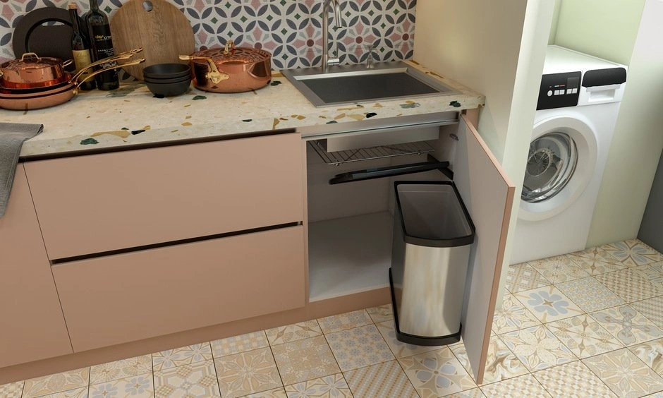 Pull-out bins and organisers improve access inside an under-sink storage cabinet.