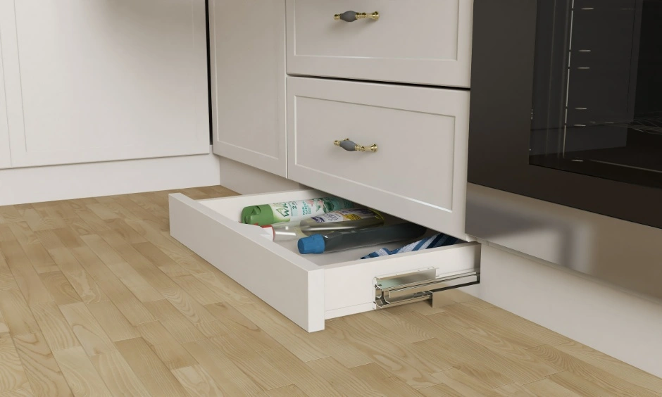 Handleless modular kitchen drawers with a skirting drawer create a clean and functional layout.