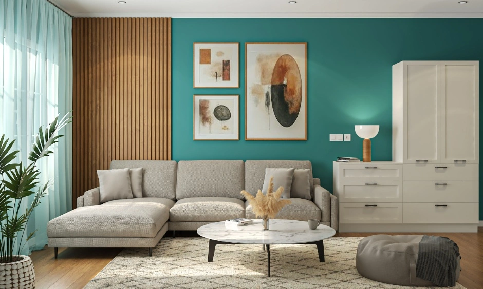 Living room wall panelling design in Noida with wooden panels, teal accent wall, sofa, coffee table, indoor plant and wall art.
