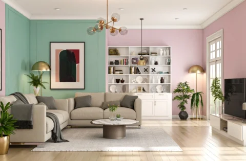 A pastel pink and pista living room features contemporary decor and warm wooden flooring