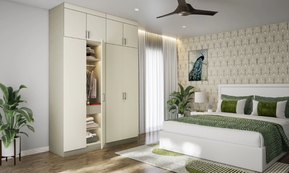 Nature-inspired bedroom with white wardrobes, leafy accents, soft daylight and green bedding.