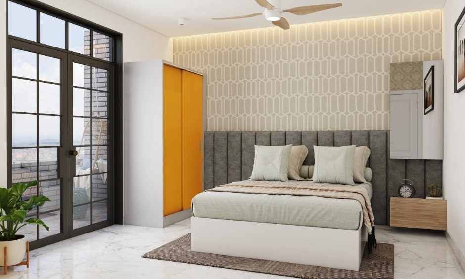 Cosy bedroom with sliding wardrobes, a soft bed wall, warm lighting and balcony access.