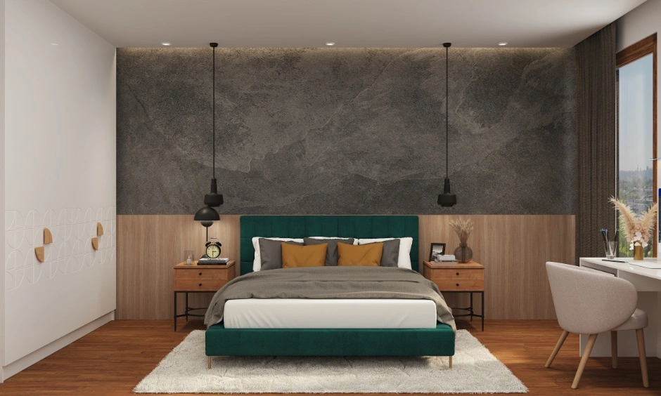 A modern bedroom features charcoal textures and a peacock green upholstered bed.