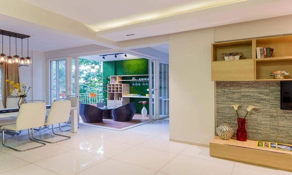 A living room features a TV unit, dining area and outdoor space within easy reach.