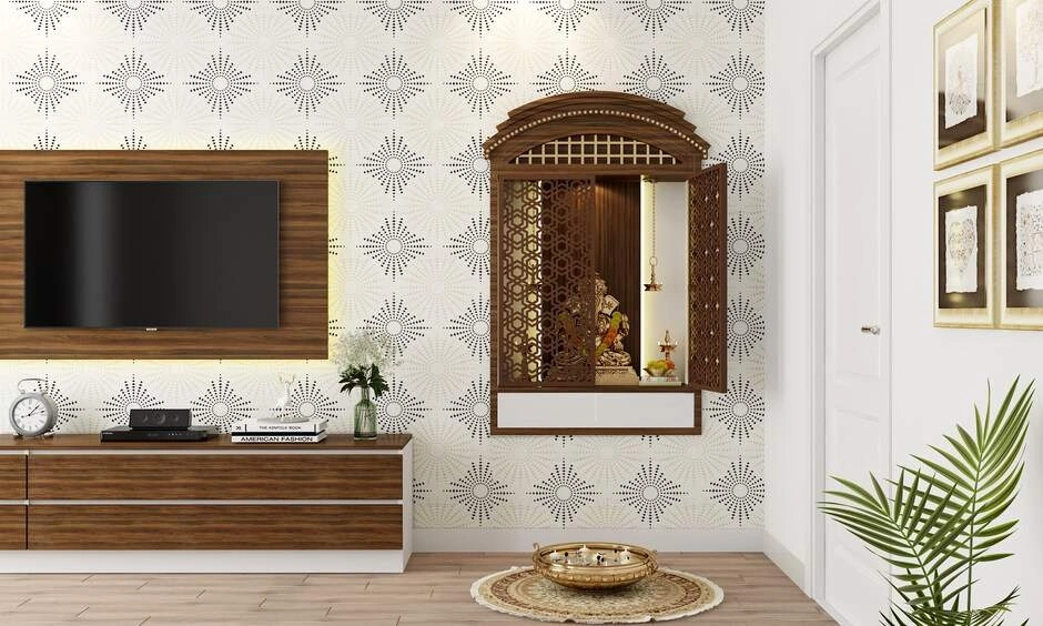 Wall-mounted wooden mandir featured in a pooja room layout with intricate white CNC jaali back panelling.