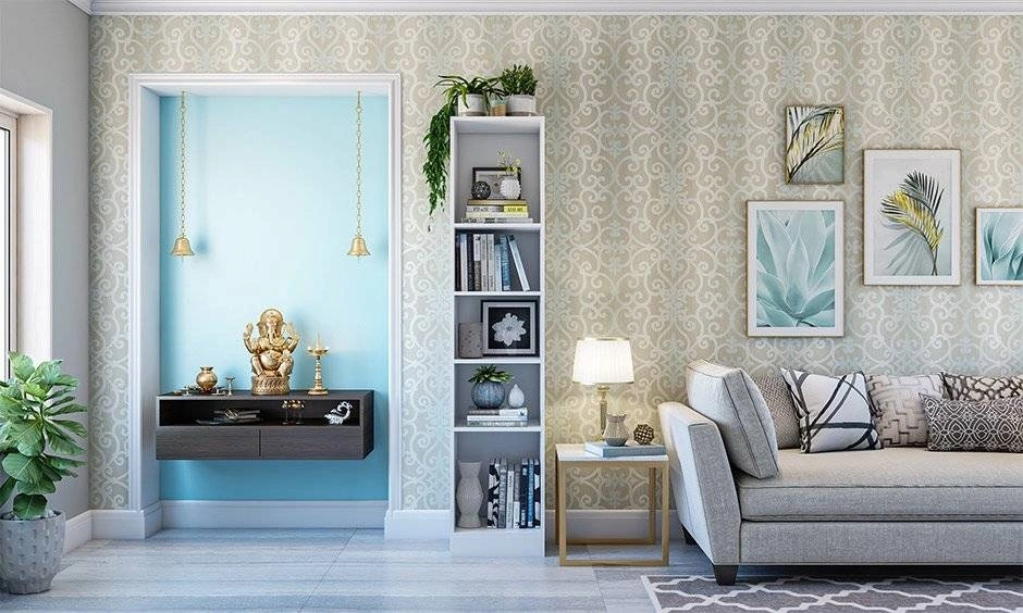 Pooja room with a soft pastel blue wall and compact prayer-space arrangement.