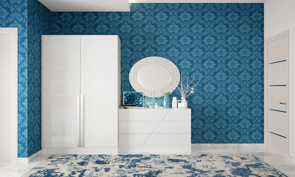 Deep sky blue wallpaper and white furniture add depth to the room.