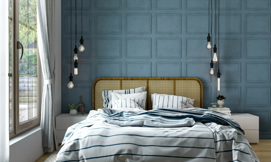 Remote-controlled lights and a fan complement the blue wall and cane headboard.