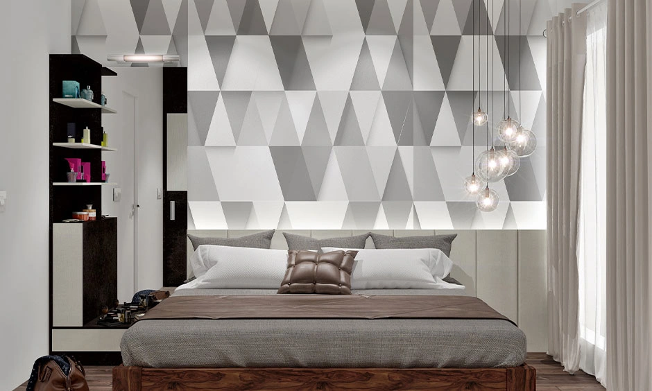 White and grey moulded triangle panels lit from below, with glass globe pendants clustered at one end.