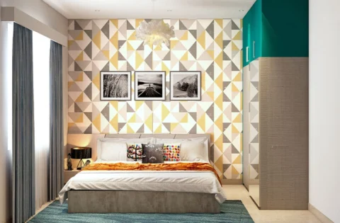 Bedroom feature wall decorated with a geometric triangle wallpaper pattern behind the bed.