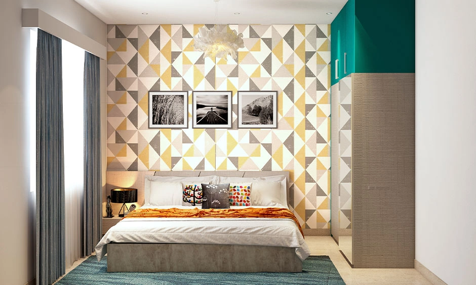 Bedroom feature wall decorated with a geometric triangle wallpaper pattern behind the bed.
