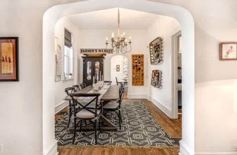 A farmhouse-style dining room features a reclaimed wooden table