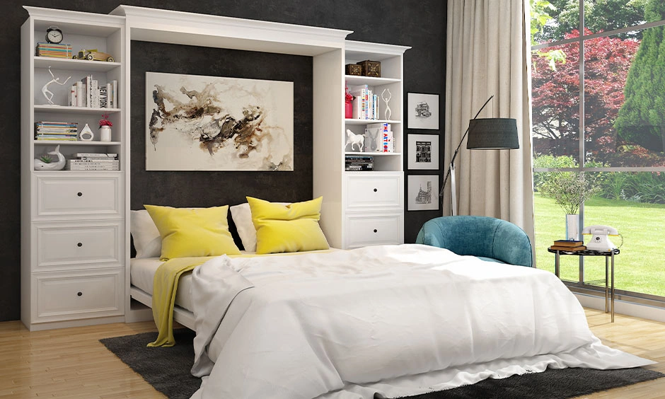 Modern bedroom with a Murphy bed, built-in shelving and warm ambient lighting.