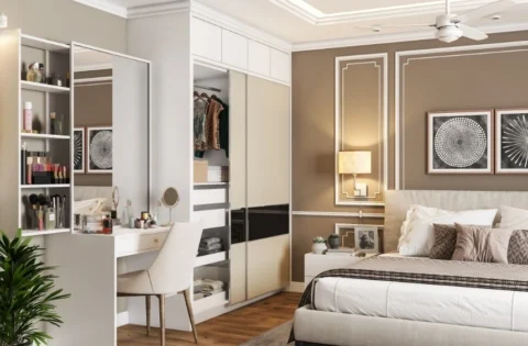 Sliding wardrobes with integrated vanity maximise storage in this Ahmedabad bedroom
