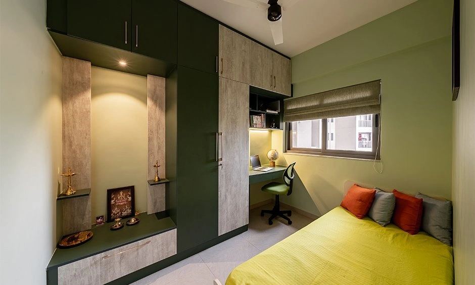 A multifunctional bedroom combines a pooja unit and study area within the same space.