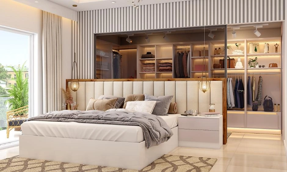 A bespoke walk-in wardrobe provides tailored storage with a clean, organised layout.