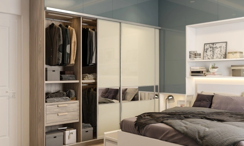 A contemporary Ahmedabad bedroom features a sliding-door wardrobe for practical storage.