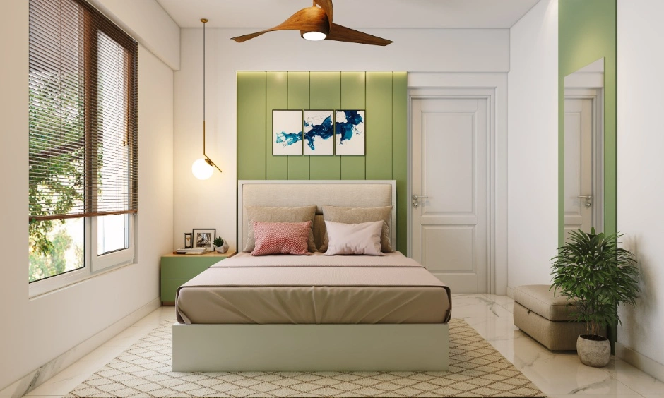A modern bedroom features wall panelling, pendant lighting and a fitted wardrobe