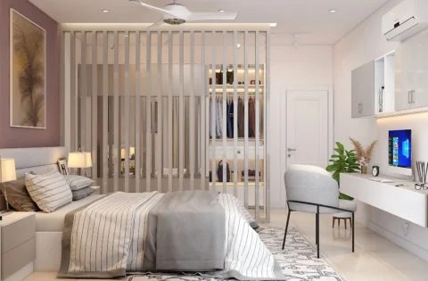 Wooden alternating partition separates the bed from a walk-in wardrobe in this modern bedroom.