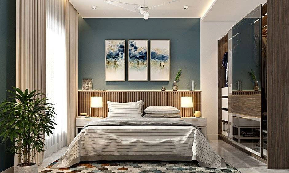 Three framed artworks create a balanced focal point above the bedroom furniture.