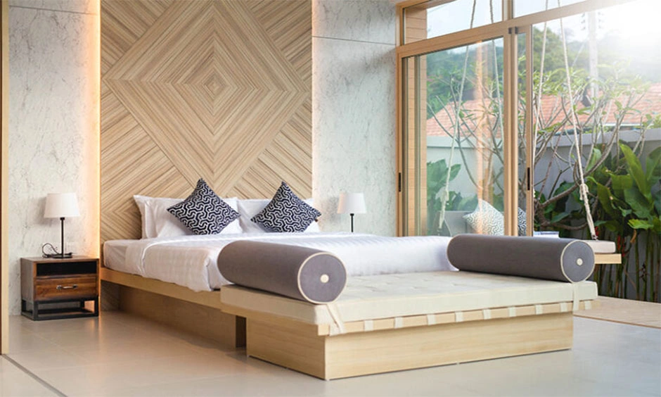 A backlit wooden wall panel provides warm ambient lighting behind the bedroom furniture.