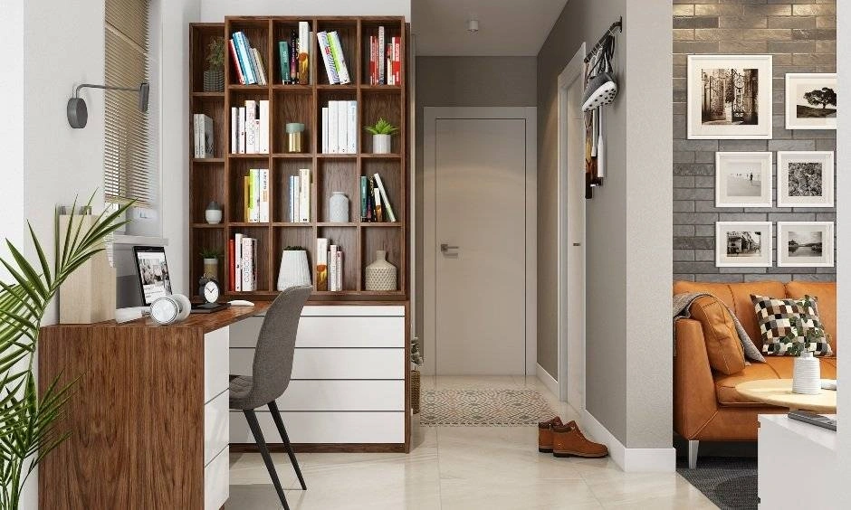 An integrated study table and bookshelf create a functional workspace in a compact room.