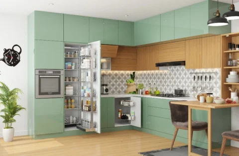 A modern kitchen combines green cabinetry, glass-finish shutters, open shelving and a light worktop