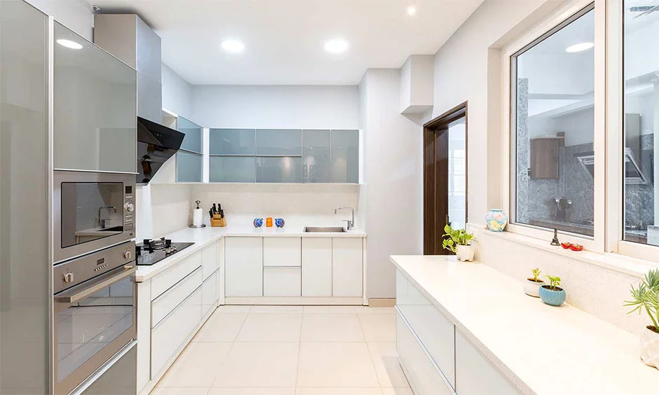 U-shaped kitchen in grey and white creates a spacious, modern look. 