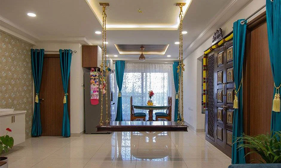 Swing and pooja room with an intricately designed door and traditional details.