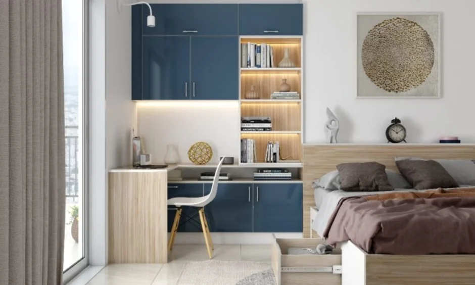 A built-in study nook and navy wall unit sit alongside the bed in this room.