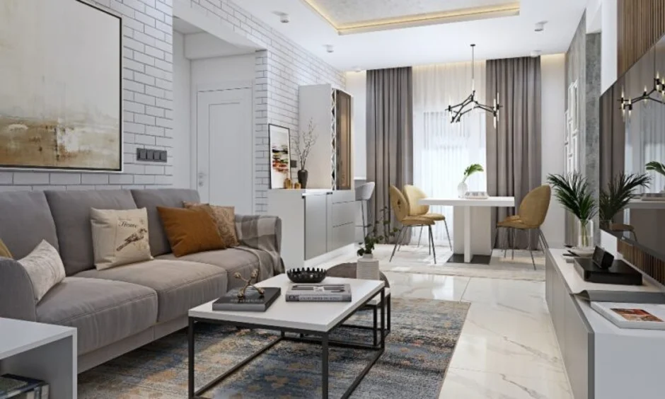 A beige sofa with mustard cushions anchors this warmly lit open living space.