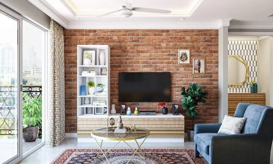 An exposed brick wall and blue armchair add character to this renovated living room.