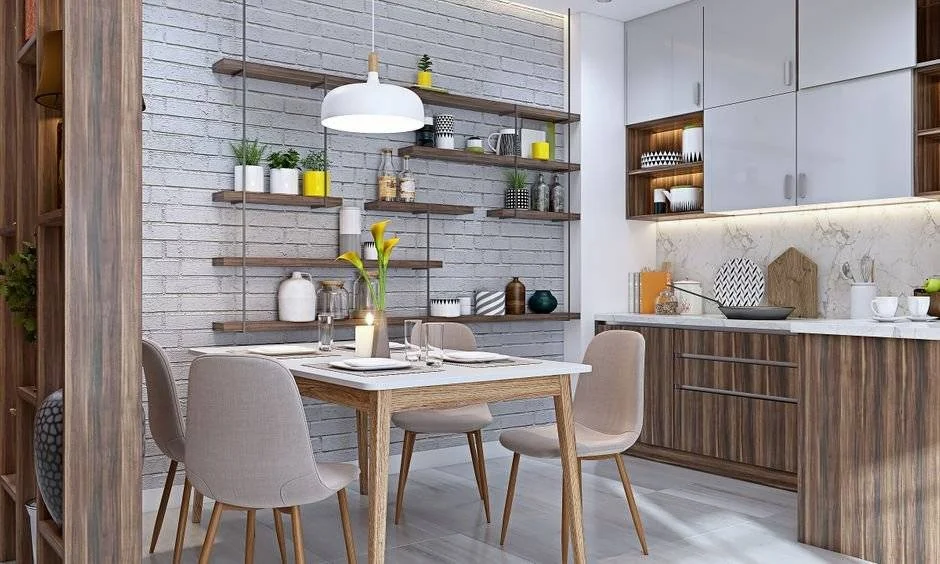 An open kitchen and dining layout combines a white brick wall with wooden furniture.