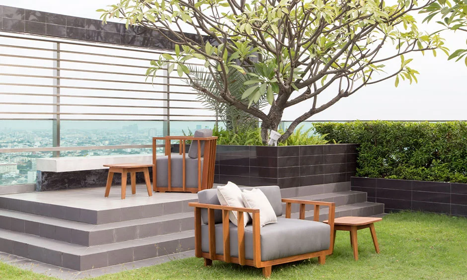 A modern rooftop terrace combines outdoor seating, timber decking and open views