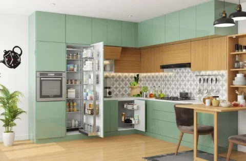 Handleless kitchen cabinets in glossy sage green and warm wood give this L-shaped kitchen a calm, uncluttered look.