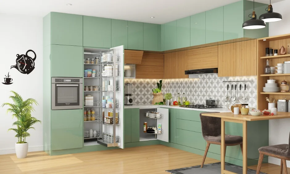 Handleless kitchen cabinets in glossy sage green and warm wood give this L-shaped kitchen a calm, uncluttered look.