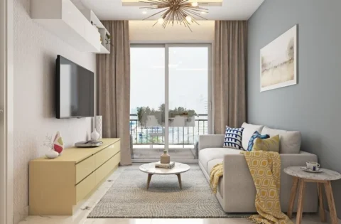 A compact living room with a low TV unit and balcony view shows what 1 BHK interior design cost in Pune covers.